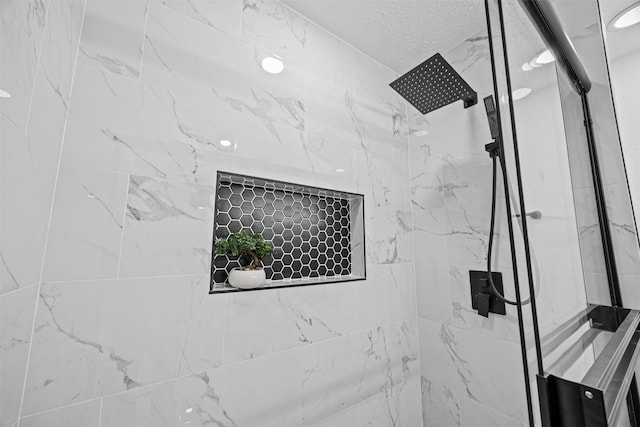 16631 Quiet Quail Dr, Missouri City, TX 77489 - bathroom view of a marble finish shower and a textured ceiling