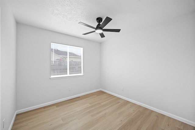 16631 Quiet Quail Dr, Missouri City, TX 77489 - unfurnished room featuring light wood finished floors, baseboards, ceiling fan, and a textured ceiling