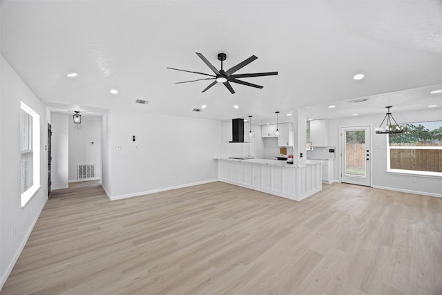 16631 Quiet Quail Dr, Missouri City, TX 77489 - unfurnished living room featuring light wood-style floors, baseboards, recessed lighting, a ceiling fan, and a chandelier
