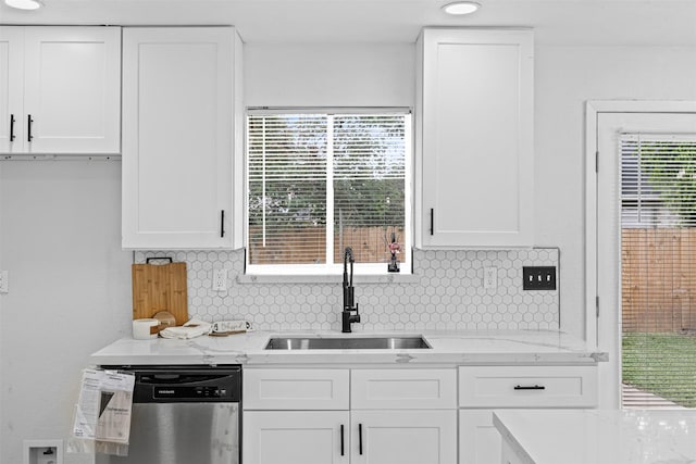 16631 Quiet Quail Dr, Missouri City, TX 77489 - kitchen featuring stainless steel dishwasher, a sink, white cabinets, backsplash, and light stone counters