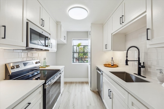 2829 Timmons Ln Unit 174, Houston, TX 77027 - kitchen with stainless steel appliances, a sink, backsplash, and light countertops