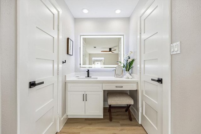 2829 Timmons Ln Unit 174, Houston, TX 77027 - bathroom with wood finished floors, vanity, and a ceiling fan