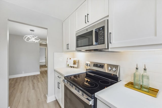 2829 Timmons Ln Unit 174, Houston, TX 77027 - kitchen with appliances with stainless steel finishes, white cabinetry, light countertops, and light wood-style flooring