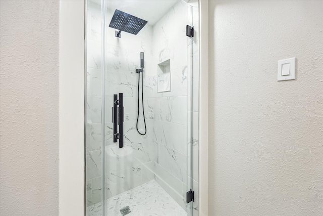 2829 Timmons Ln Unit 174, Houston, TX 77027 - full bathroom featuring a textured wall and a marble finish shower