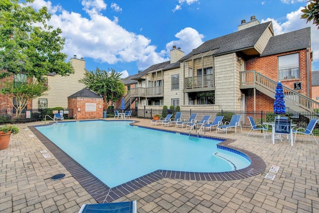 2829 Timmons Ln Unit 174, Houston, TX 77027 - community pool featuring stairs and a patio area