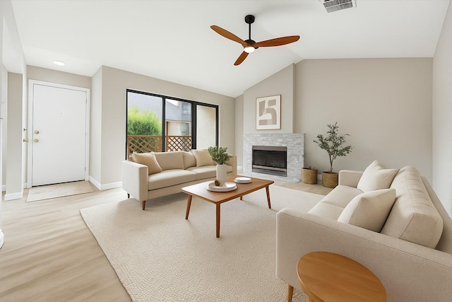 2829 Timmons Ln Unit 174, Houston, TX 77027 - living area featuring light wood-style flooring, a ceiling fan, baseboards, vaulted ceiling, and a fireplace