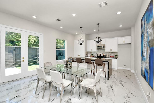 6551 Sealey St, Houston, TX 77091 - dining room featuring light marble finish floors, french doors, recessed lighting, and baseboards