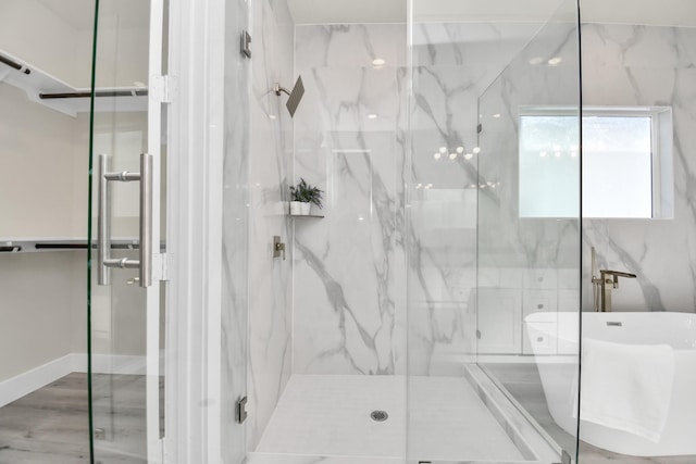 6551 Sealey St, Houston, TX 77091 - full bathroom featuring a marble finish shower and wood finished floors