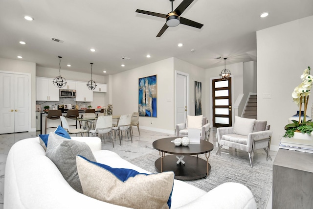 6551 Sealey St, Houston, TX 77091 - living area with recessed lighting, baseboards, stairway, light marble finish flooring, and a ceiling fan