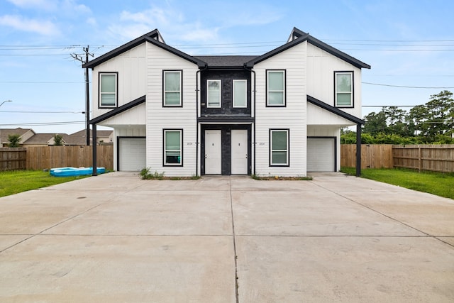 8534 Woodlyn Rd, Houston, TX 77028 - view of front of home featuring concrete driveway, board and batten siding, and an attached garage