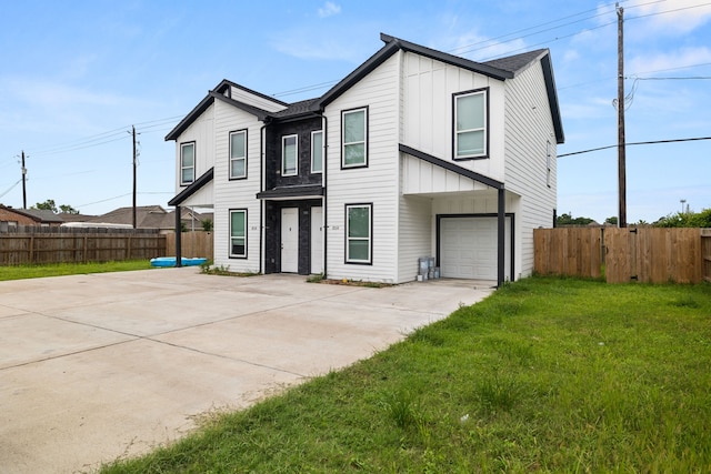 8534 Woodlyn Rd, Houston, TX 77028 - view of front facade featuring board and batten siding, concrete driveway, and a garage