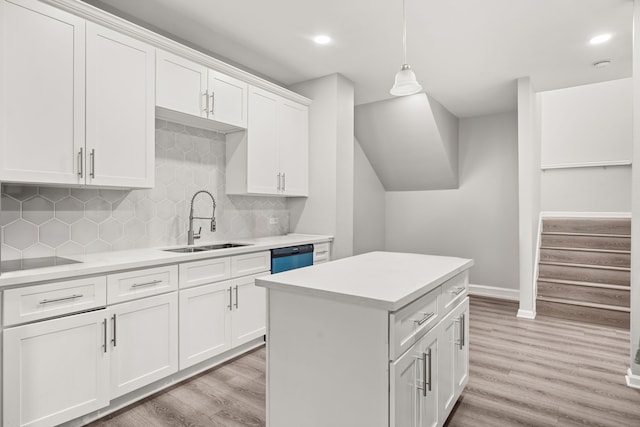 8534 Woodlyn Rd, Houston, TX 77028 - kitchen featuring light wood-type flooring, light countertops, white cabinetry, hanging light fixtures, and recessed lighting