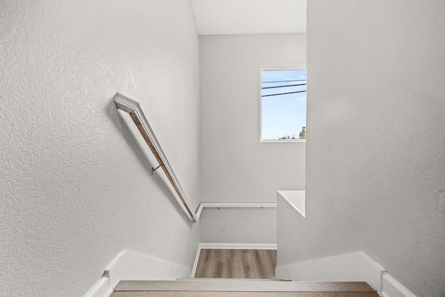 8534 Woodlyn Rd, Houston, TX 77028 - stairway with wood finished floors and a textured wall