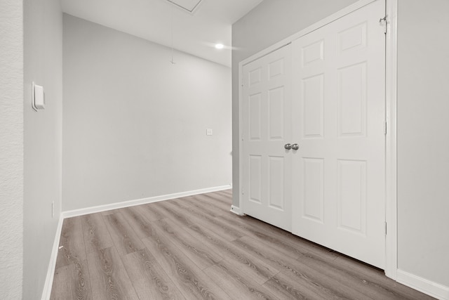 8534 Woodlyn Rd, Houston, TX 77028 - unfurnished bedroom featuring attic access, wood finished floors, and recessed lighting