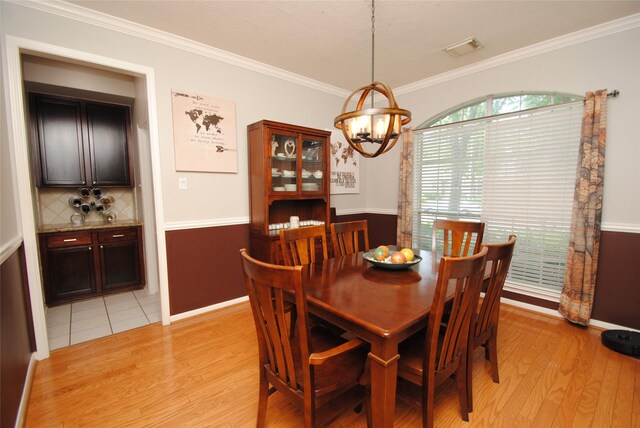 9723 Therrell Dr, Houston, TX 77064 - dining room with a chandelier, light wood finished floors, ornamental molding, and baseboards