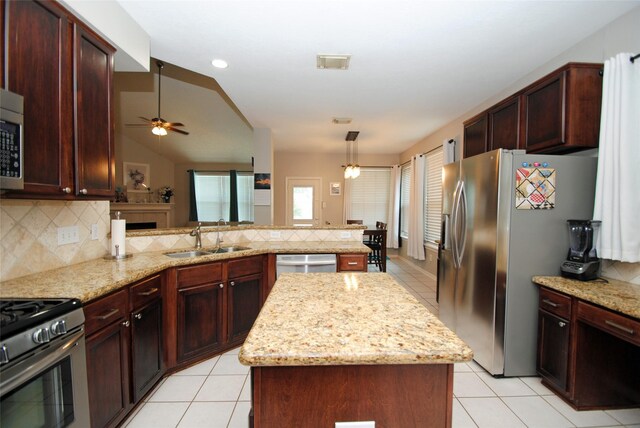 9723 Therrell Dr, Houston, TX 77064 - kitchen with a sink, appliances with stainless steel finishes, a peninsula, tasteful backsplash, and ceiling fan