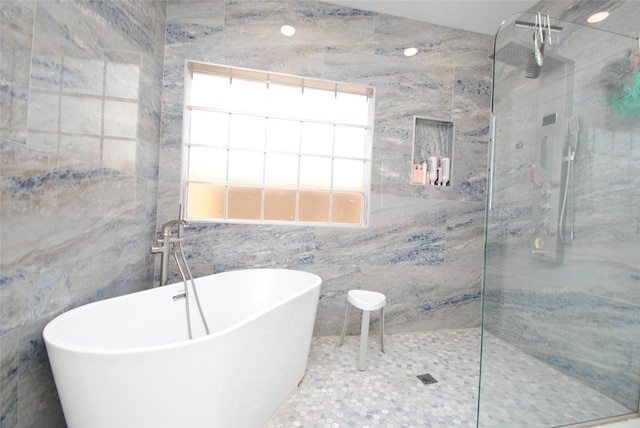 9723 Therrell Dr, Houston, TX 77064 - full bathroom featuring a marble finish shower, a freestanding bath, and tile walls