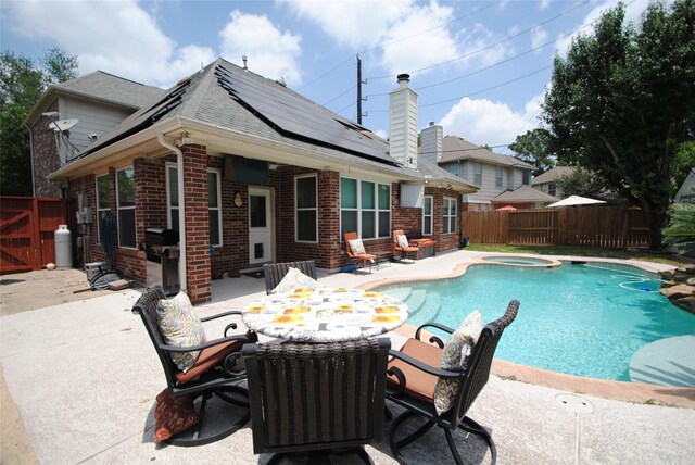 9723 Therrell Dr, Houston, TX 77064 - view of pool with a patio, a fenced backyard, outdoor dining space, and a pool with connected hot tub