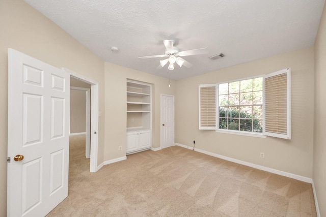 22127 Glen Arden Ln, Katy, TX 77450 - unfurnished bedroom featuring baseboards, light colored carpet, a textured ceiling, and a ceiling fan