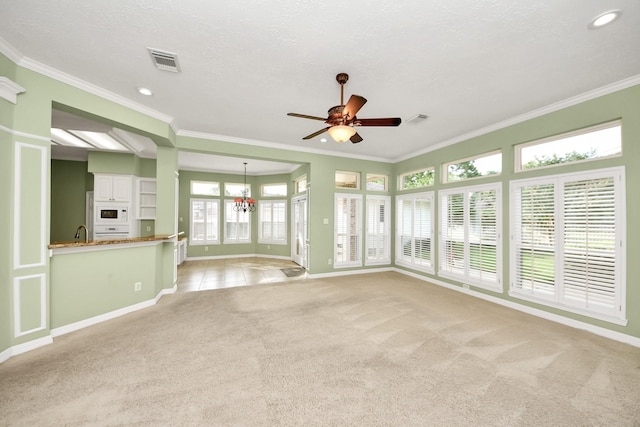 22127 Glen Arden Ln, Katy, TX 77450 - unfurnished living room with baseboards, light carpet, crown molding, ceiling fan, and a chandelier