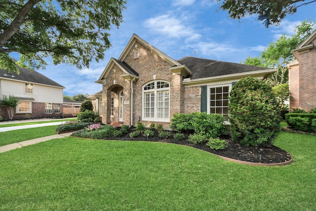 22127 Glen Arden Ln, Katy, TX 77450 - view of front of house featuring a front lawn, brick siding, and a shingled roof