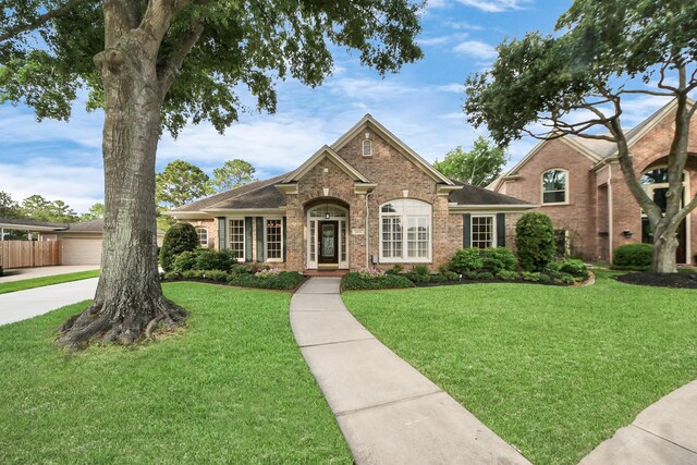 22127 Glen Arden Ln, Katy, TX 77450 - traditional home with brick siding and a front lawn
