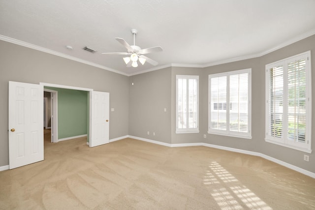 22127 Glen Arden Ln, Katy, TX 77450 - empty room with light colored carpet, ceiling fan, baseboards, plenty of natural light, and ornamental molding