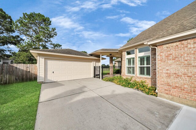 22127 Glen Arden Ln, Katy, TX 77450 - exterior space with a garage, brick siding, and an outbuilding