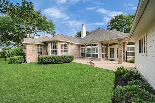 22127 Glen Arden Ln, Katy, TX 77450 - back of house featuring brick siding, a chimney, a patio area, and roof with shingles