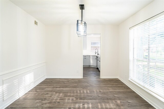 17426 Pinewood Forest Dr, Spring, TX 77379 - unfurnished dining area with dark wood-style flooring and baseboards