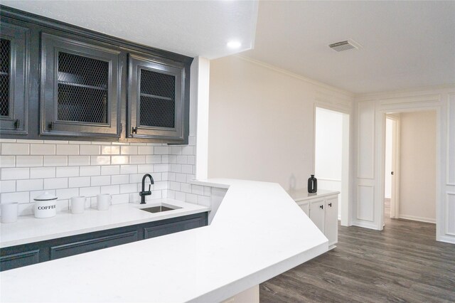 17426 Pinewood Forest Dr, Spring, TX 77379 - bar with a sink, tasteful backsplash, dark wood finished floors, ornamental molding, and baseboards