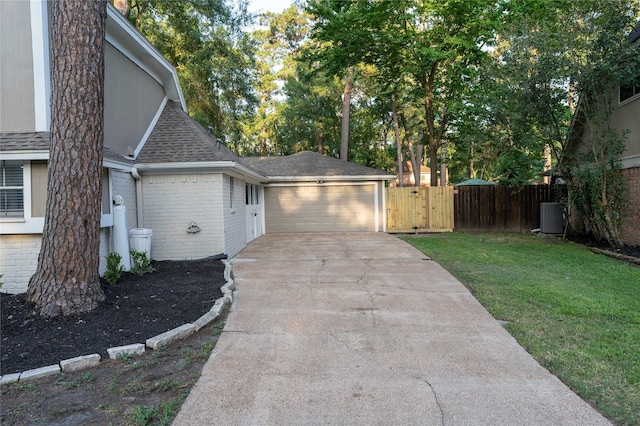 17426 Pinewood Forest Dr, Spring, TX 77379 - view of side of property featuring a shingled roof, brick siding, a garage, concrete driveway, and cooling unit