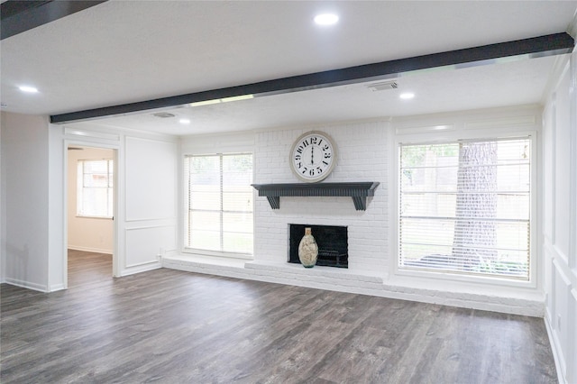 17426 Pinewood Forest Dr, Spring, TX 77379 - unfurnished living room with baseboards, wood finished floors, a fireplace, healthy amount of natural light, and beamed ceiling