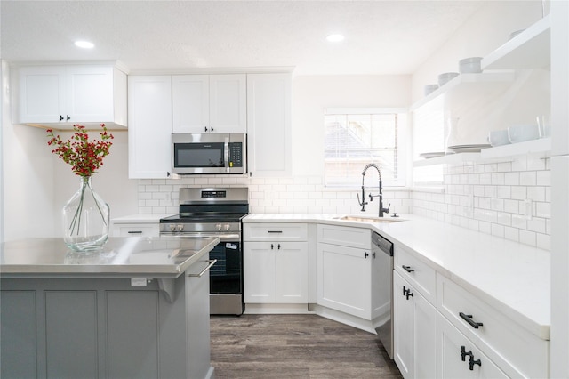 17426 Pinewood Forest Dr, Spring, TX 77379 - kitchen featuring appliances with stainless steel finishes, a sink, light countertops, white cabinets, and recessed lighting