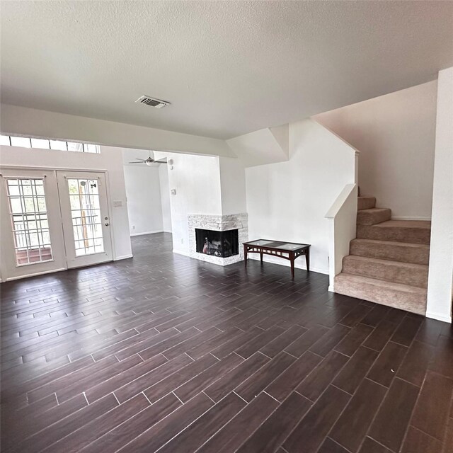 16800 Sugar Pine Dr Unit C21, Houston, TX 77090 - living room featuring a ceiling fan, wood tiled floors, stairs, a multi sided fireplace, and a textured ceiling
