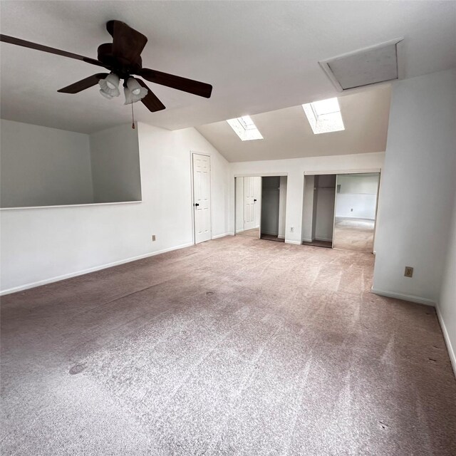 16800 Sugar Pine Dr Unit C21, Houston, TX 77090 - carpeted spare room with lofted ceiling, baseboards, a ceiling fan, and a skylight