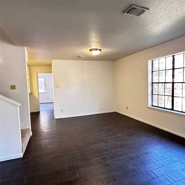 16800 Sugar Pine Dr Unit C21, Houston, TX 77090 - empty room with dark wood finished floors, baseboards, and a textured ceiling