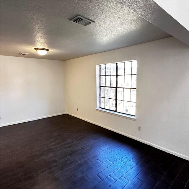 16800 Sugar Pine Dr Unit C21, Houston, TX 77090 - empty room featuring baseboards, dark wood finished floors, and a textured ceiling