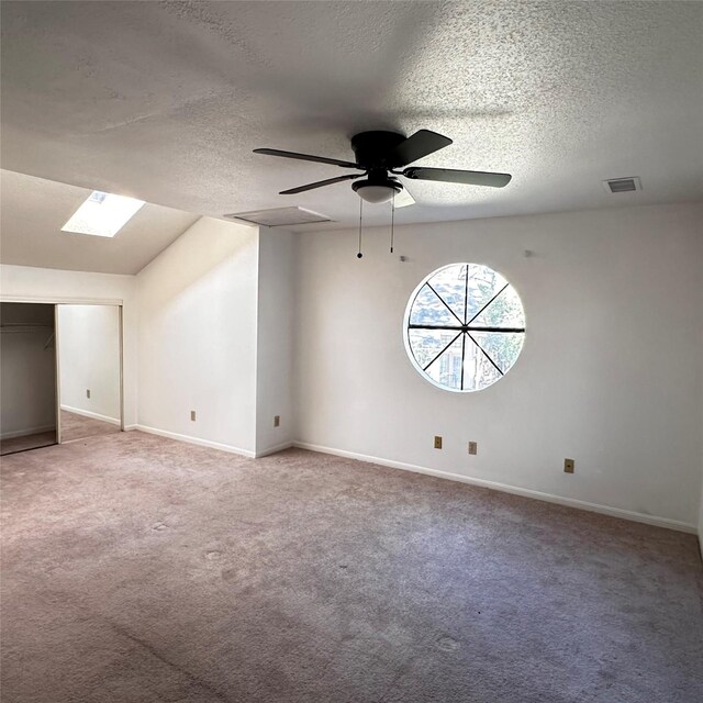 16800 Sugar Pine Dr Unit C21, Houston, TX 77090 - unfurnished room featuring a textured ceiling, a skylight, carpet floors, a ceiling fan, and baseboards