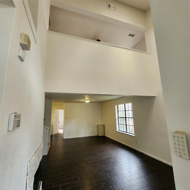 16800 Sugar Pine Dr Unit C21, Houston, TX 77090 - unfurnished living room with wood tiled floors, a high ceiling, and baseboards