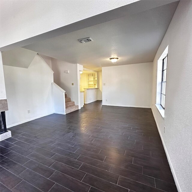 16800 Sugar Pine Dr Unit C21, Houston, TX 77090 - unfurnished living room with wood finish floors, baseboards, stairs, and a fireplace with raised hearth