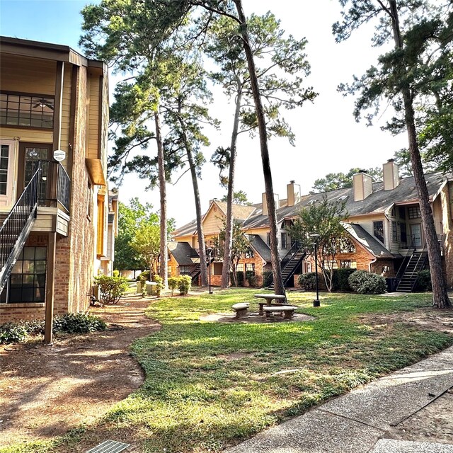 16800 Sugar Pine Dr Unit C21, Houston, TX 77090 - view of community featuring stairs, a residential view, and a yard