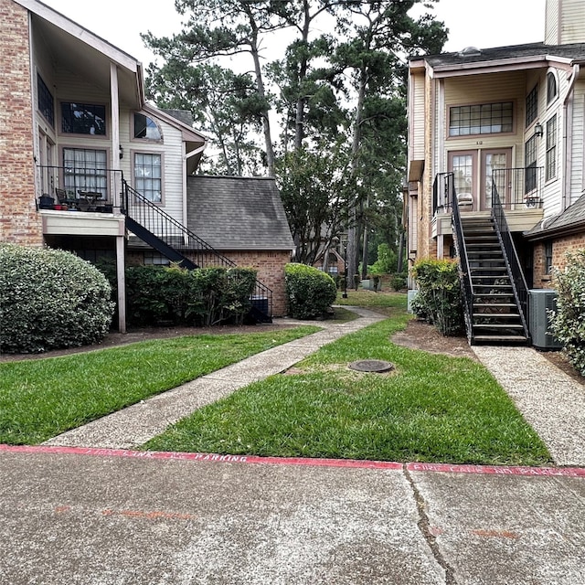 16800 Sugar Pine Dr Unit C21, Houston, TX 77090 - view of green lawn with stairs and cooling unit