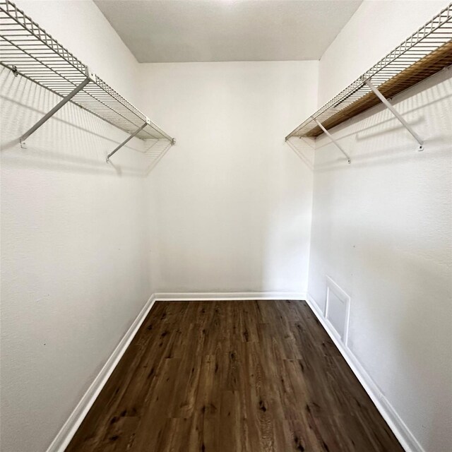16800 Sugar Pine Dr Unit C21, Houston, TX 77090 - walk in closet with dark wood finished floors