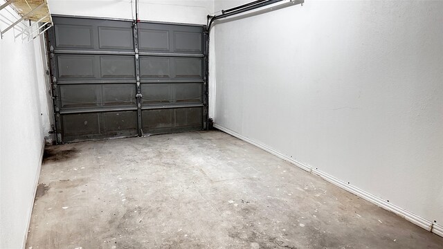 16800 Sugar Pine Dr Unit C21, Houston, TX 77090 - garage featuring baseboards