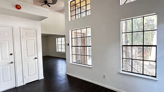 16800 Sugar Pine Dr Unit C21, Houston, TX 77090 - entrance foyer featuring baseboards, ceiling fan, dark wood finished floors, a textured wall, and a high ceiling