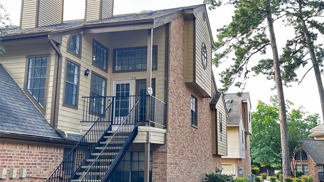 16800 Sugar Pine Dr Unit C21, Houston, TX 77090 - view of side of home with brick siding and stairway