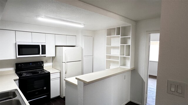 16800 Sugar Pine Dr Unit C21, Houston, TX 77090 - kitchen featuring white microwave, black electric range, light countertops, white cabinetry, and a peninsula