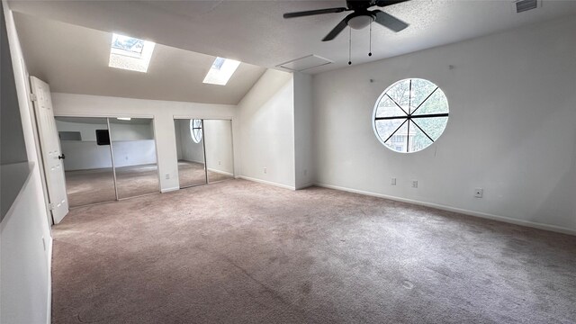 16800 Sugar Pine Dr Unit C21, Houston, TX 77090 - unfurnished bedroom featuring carpet floors, multiple closets, lofted ceiling, baseboards, and ceiling fan