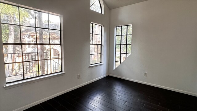 16800 Sugar Pine Dr Unit C21, Houston, TX 77090 - spare room featuring baseboards and dark wood-style flooring